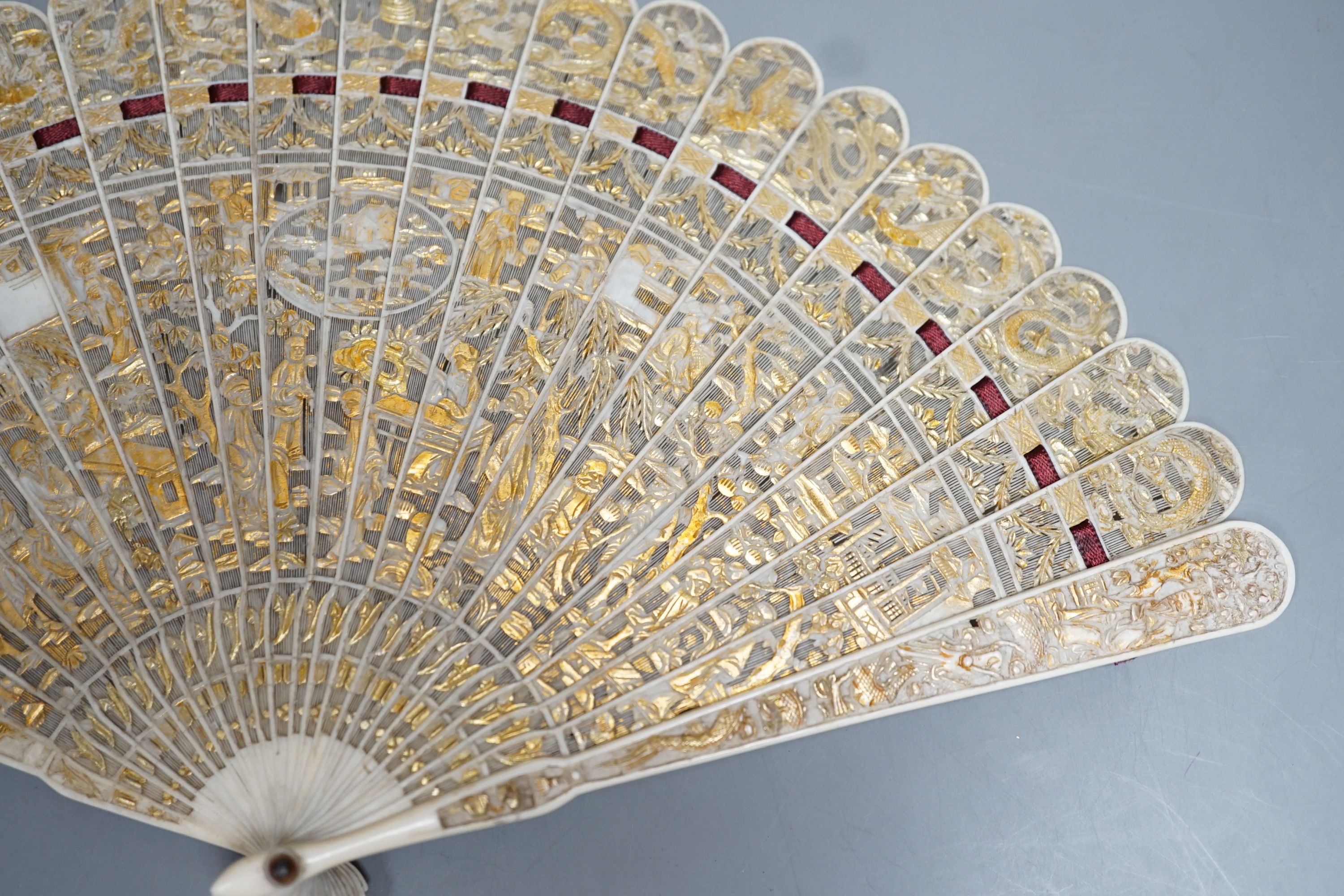 A 19th century Chinese export pierced ivory brise fan, gilded sticks, 19cm